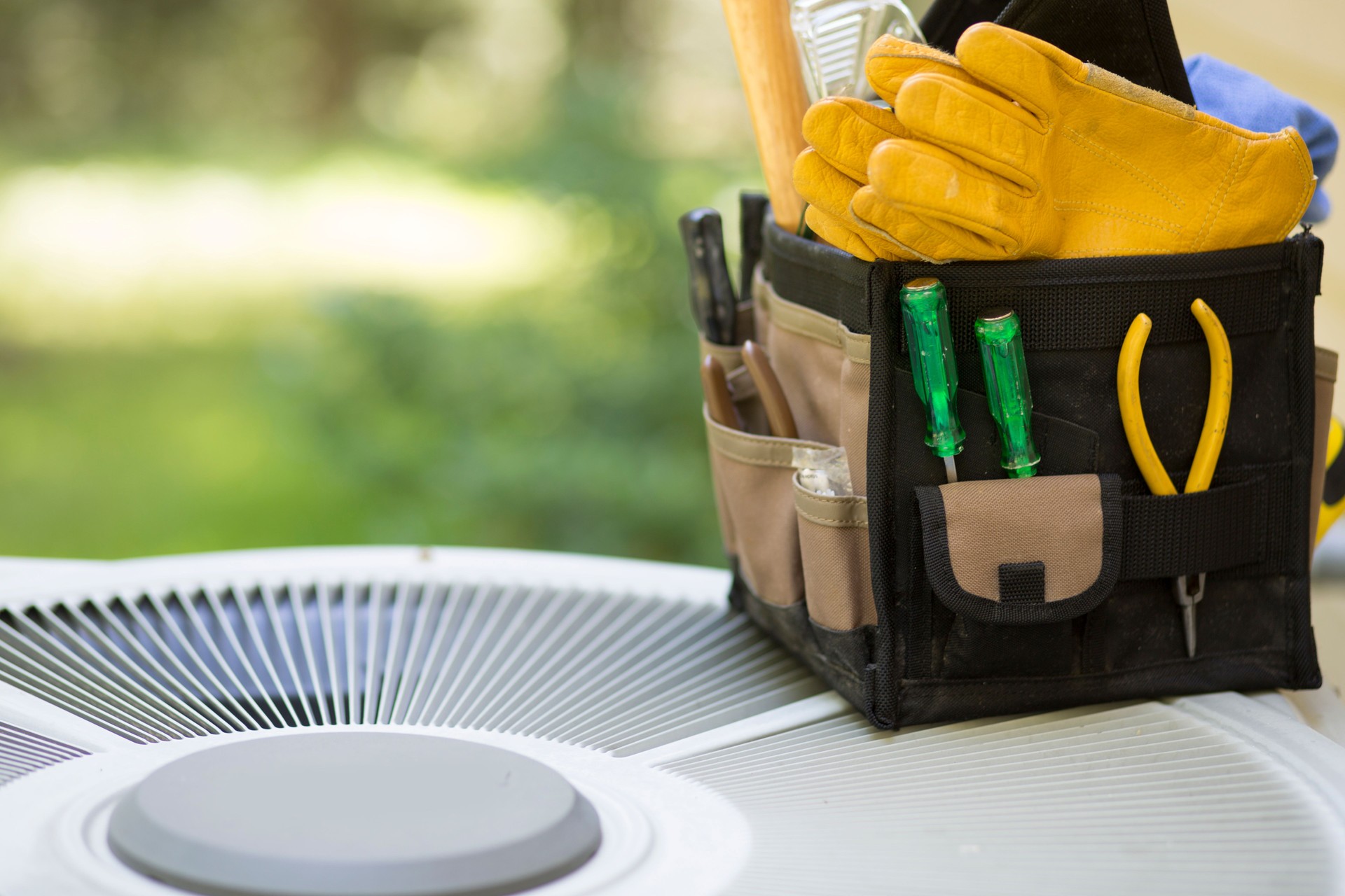Air conditioning service personnel keep home owner unit running efficiently to help save carbon footprint.